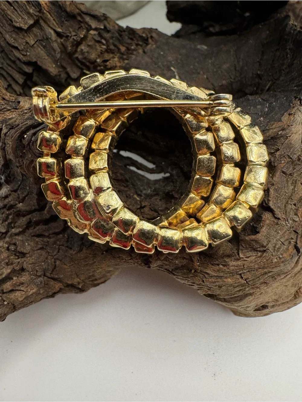 Vintage 3-ring rhinestone brooch, EUC. 1 1/2” x 1 1/4”. Gold tone metal.